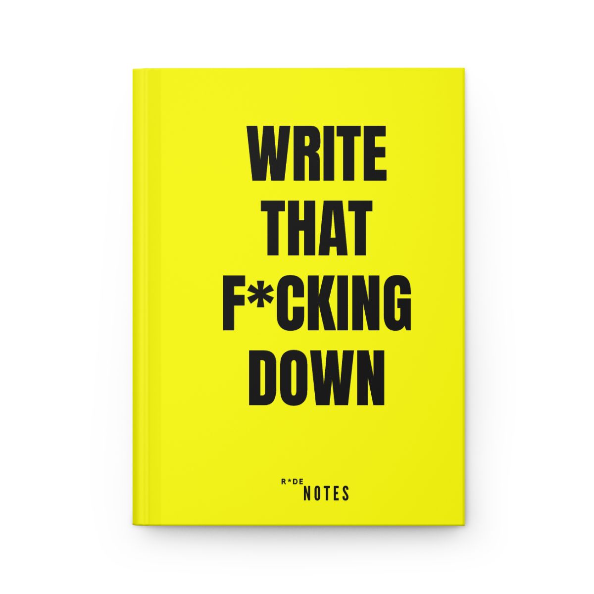 Yellow hardback notebook reading WRITE THAT F*CKING DOWN in bold black type
